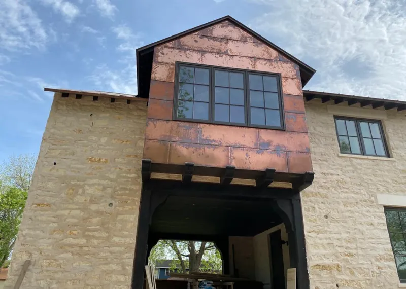 Copper metal panel facade on a stone building for Skylight Installation in Fresno